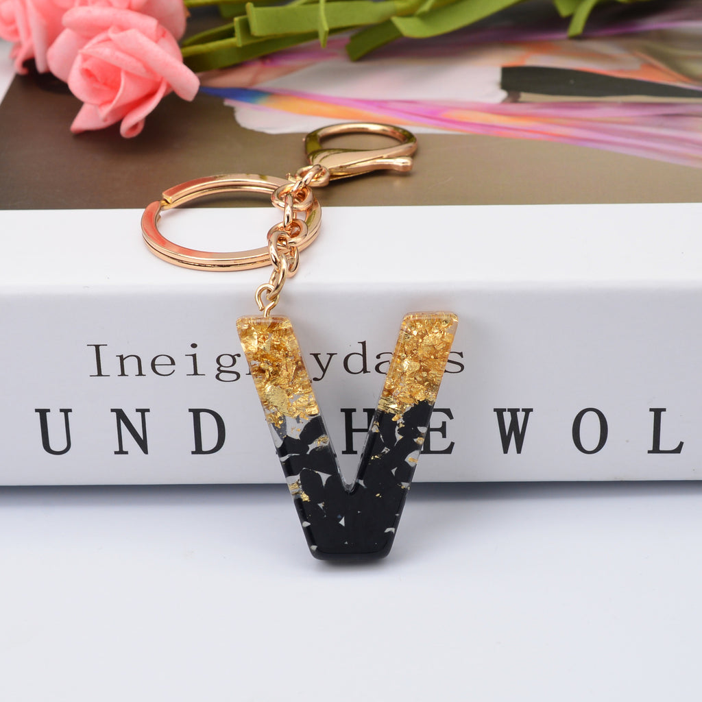 Carsine Black Pompom 26 Alphabets Keychain gold / V